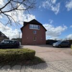 Haus von Vorne mit Parkplätzen
